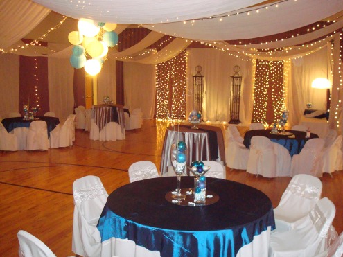 Tent set up with Dance floor in the center and tables surrounding it